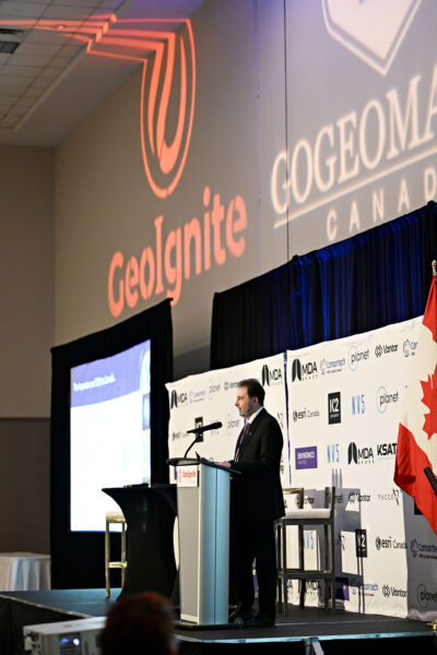 Guennadi Kroupnik delivering his keynote at GeoIgnite 2026 in Ottawa